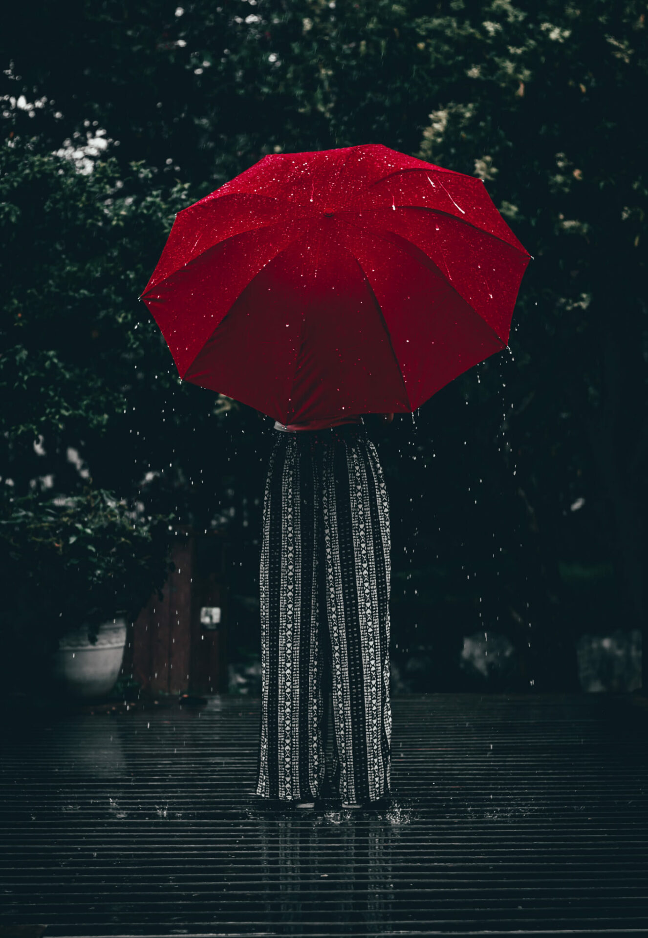 person standing using red umbrella 1887792