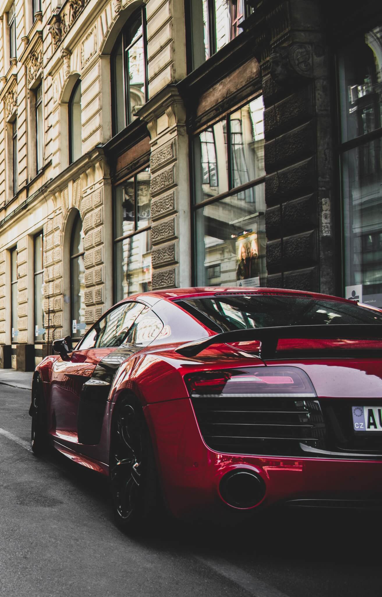 red and black audi r8 coupe parked near gray concrete 1545743