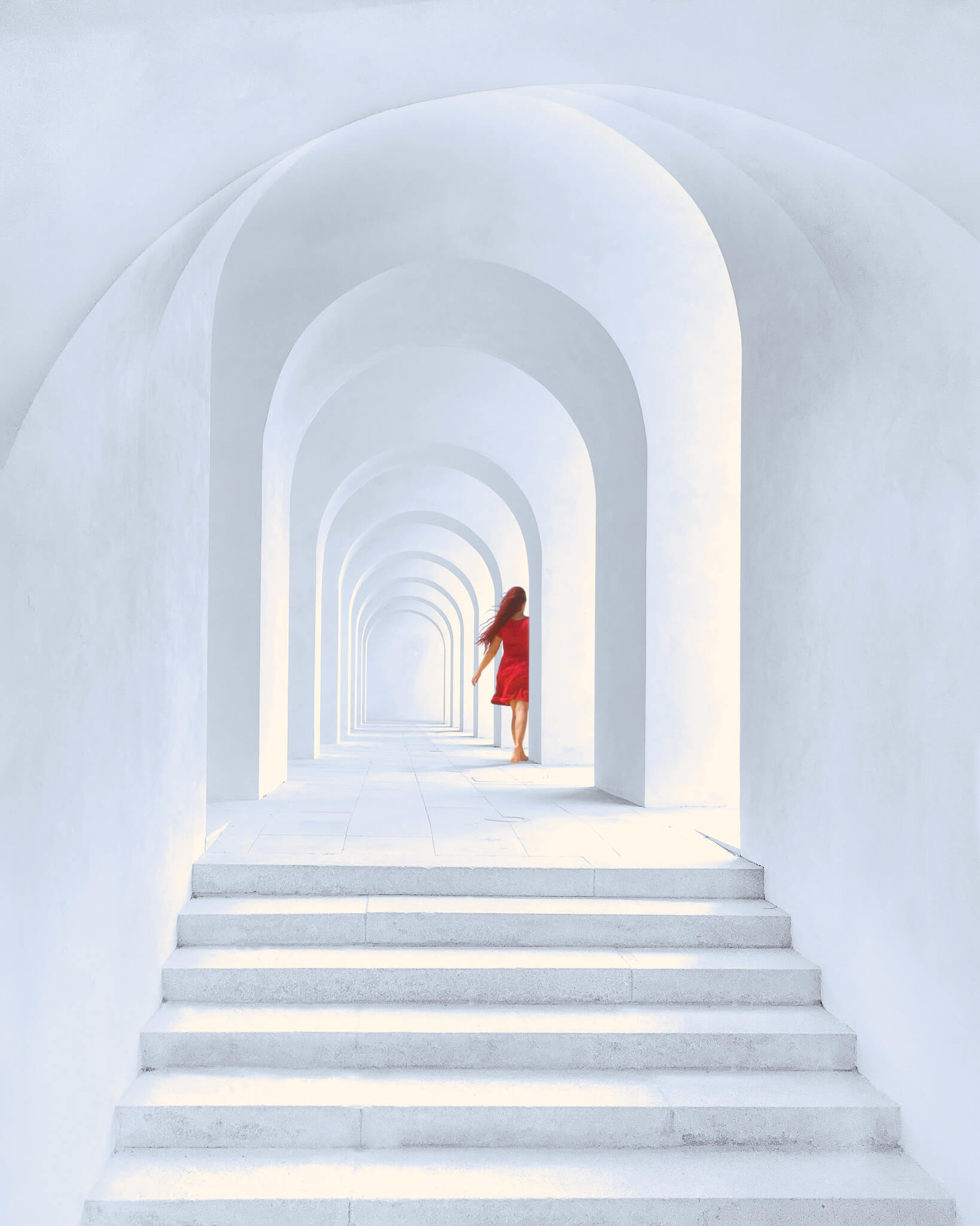 woman in red dress standing in white arch building 1874726